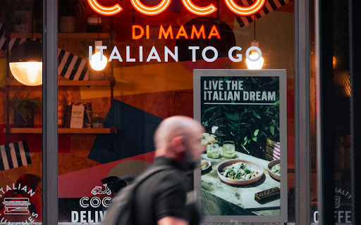 A man walking past a cafe with the words coco di mamma italian to go from Chrome web store to be run with OffiDocs Chromium online A man walking past a cafe with the words coco di mamma italian to go from Chrome web store to be run with OffiDocs Chromium online